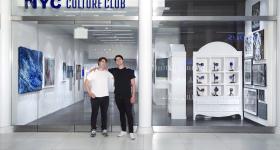 Clayton and Parker Calvert stand in front of a building named "NYC Culture Club."C Culture