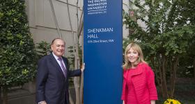 Alumnus Mark Shenkman and his wife, Rosalind, stand outside of his namesake residence hall on the Foggy Bottom campus.