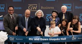 Provost Christopher Bracey, GWSB Dean Anuj Mehrotra, President Ellen M. Granberg, Dawn Duquès, Ric Duquès and the Duquès grandchildren.